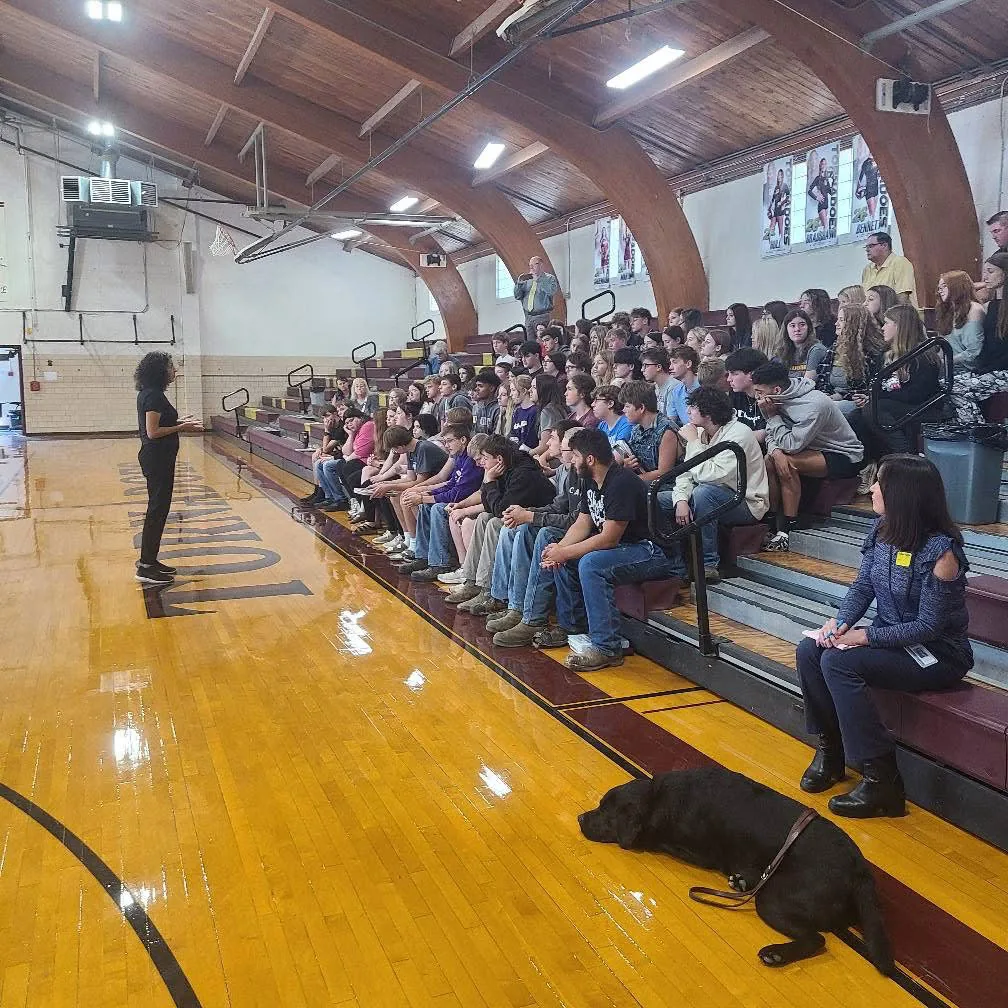Jodee Blanco presenting to students in a gym